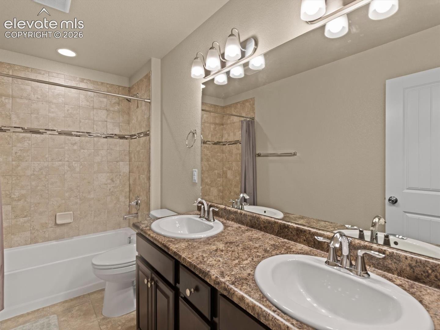 Double vanity featuring oval undermount sinks and chrome fixtures