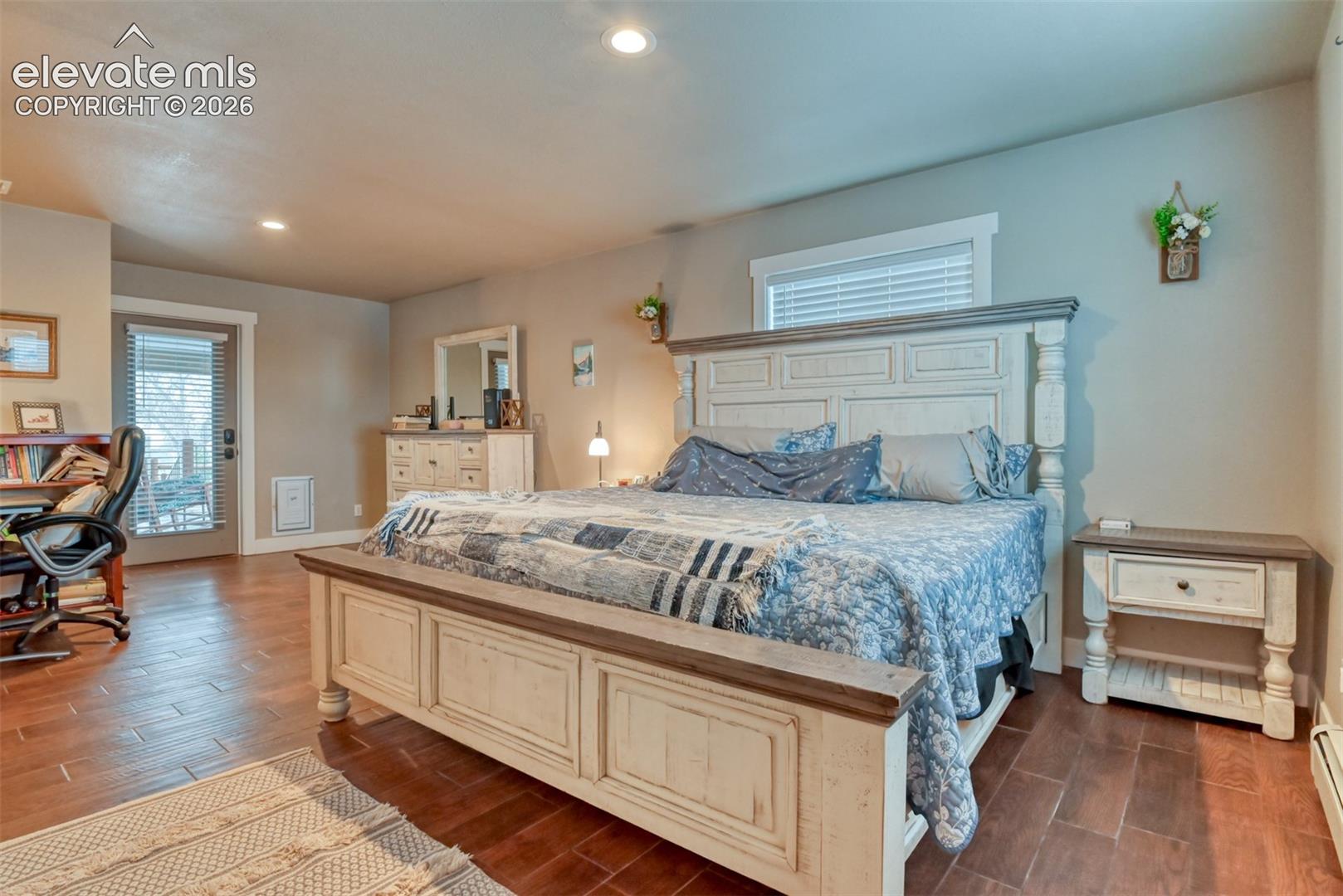 Bedroom featuring wood finish floors, recessed lighting, and access to exterior