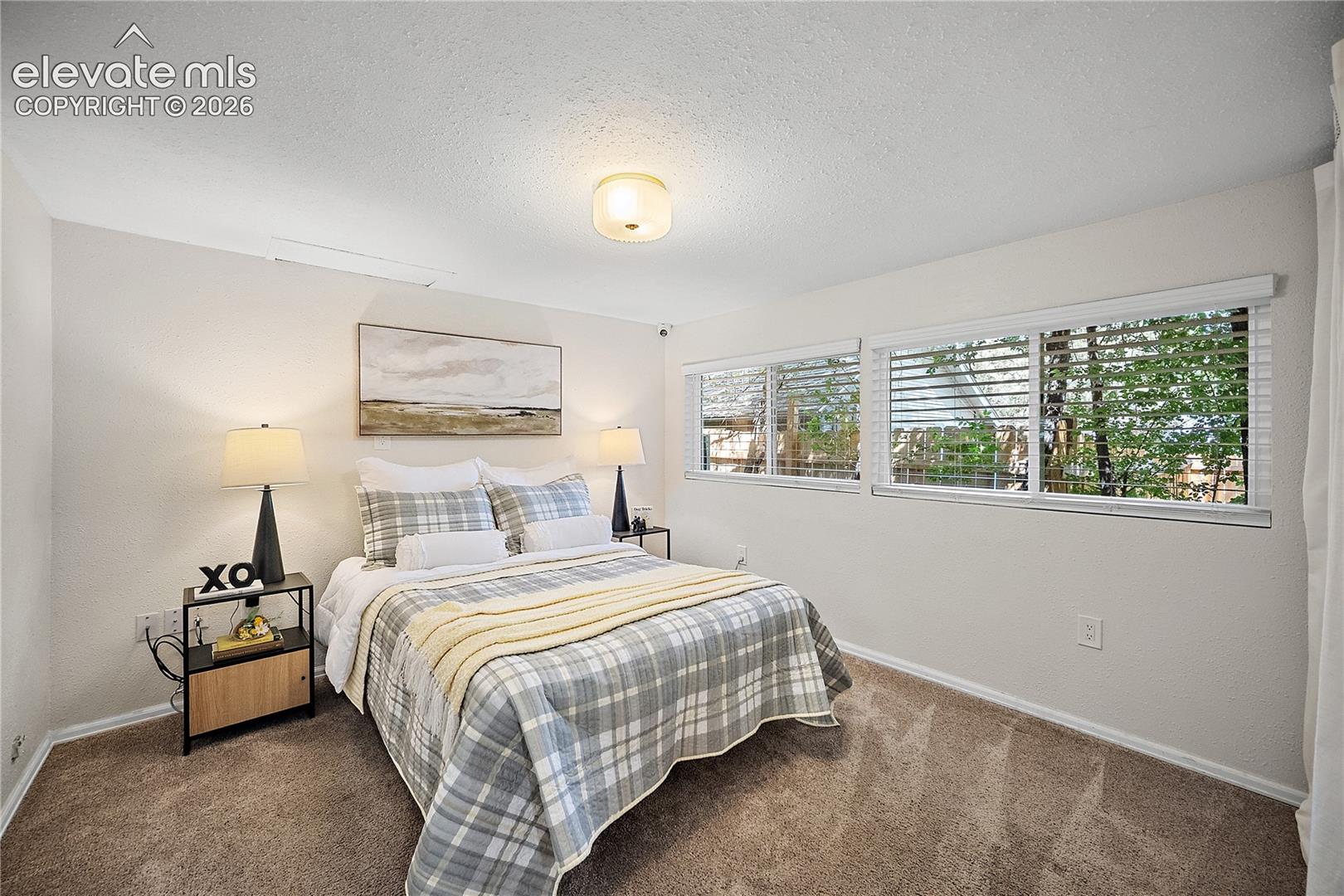 Bedroom featuring light-colored walls and soft carpet flooring