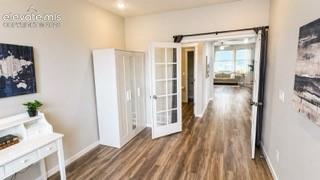 Primary level bedroom or office space. Tall ceilings, recessed lighting, LVP floors, French doors & next to half bath.
