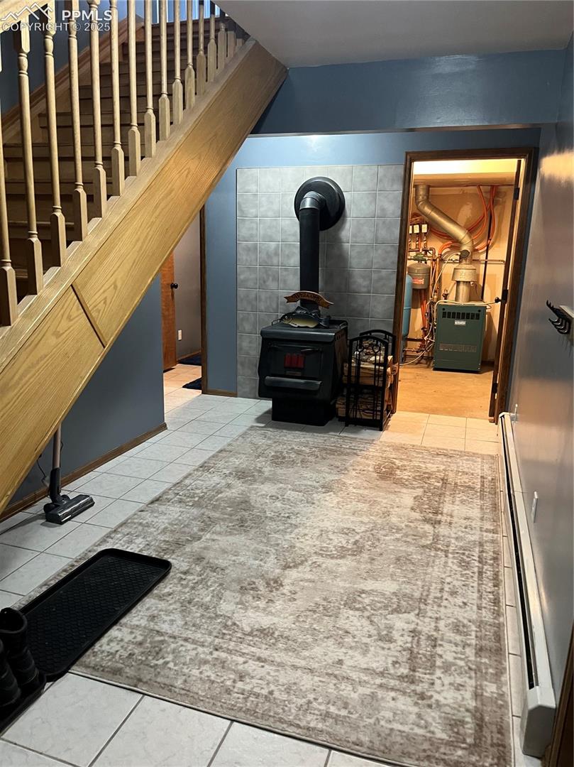 Lower entry way.   To the right is the inside entrance to the oversized garage.  Wood buring stove and mechanical area.