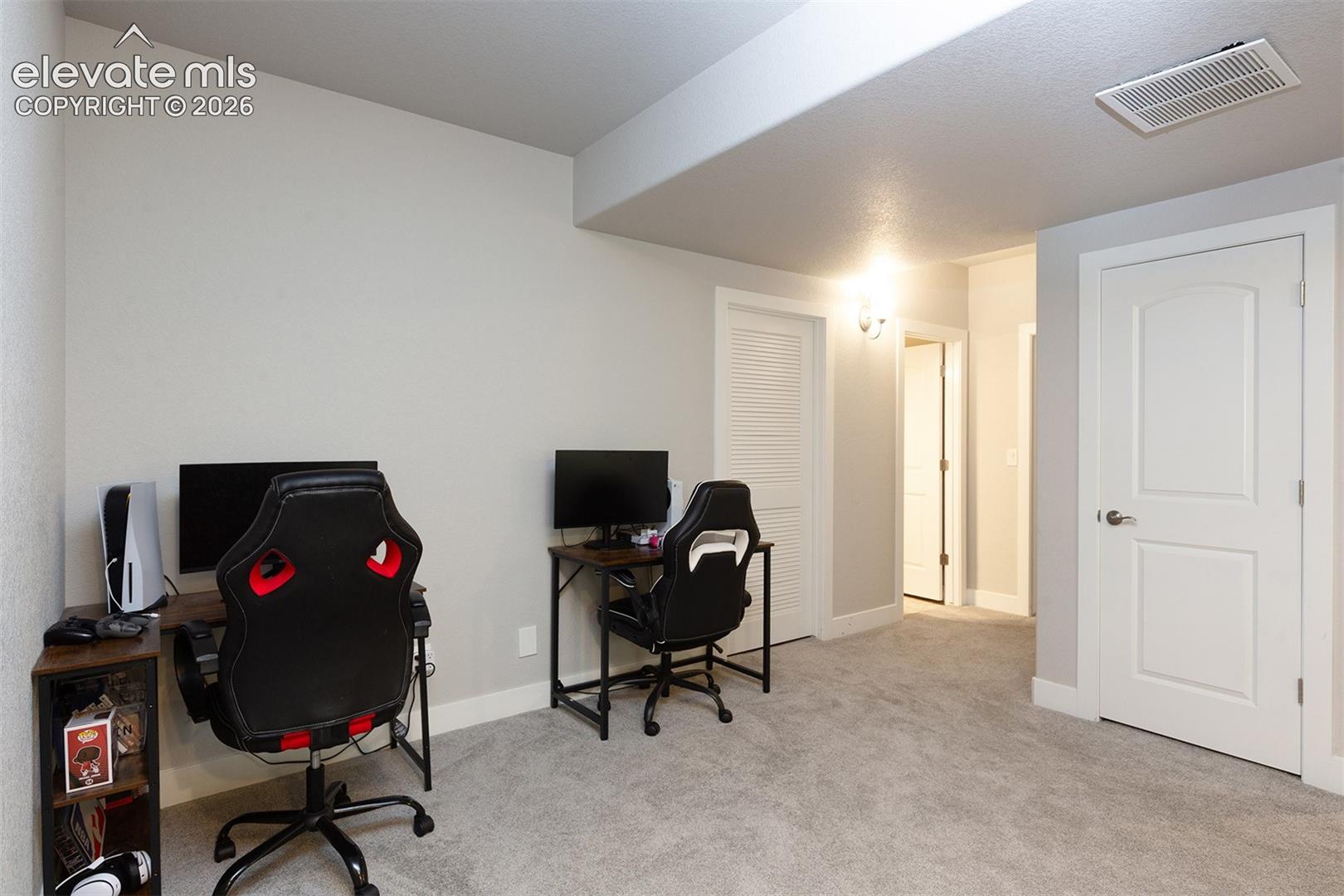 Light gray walls, light gray carpeting, and white trim