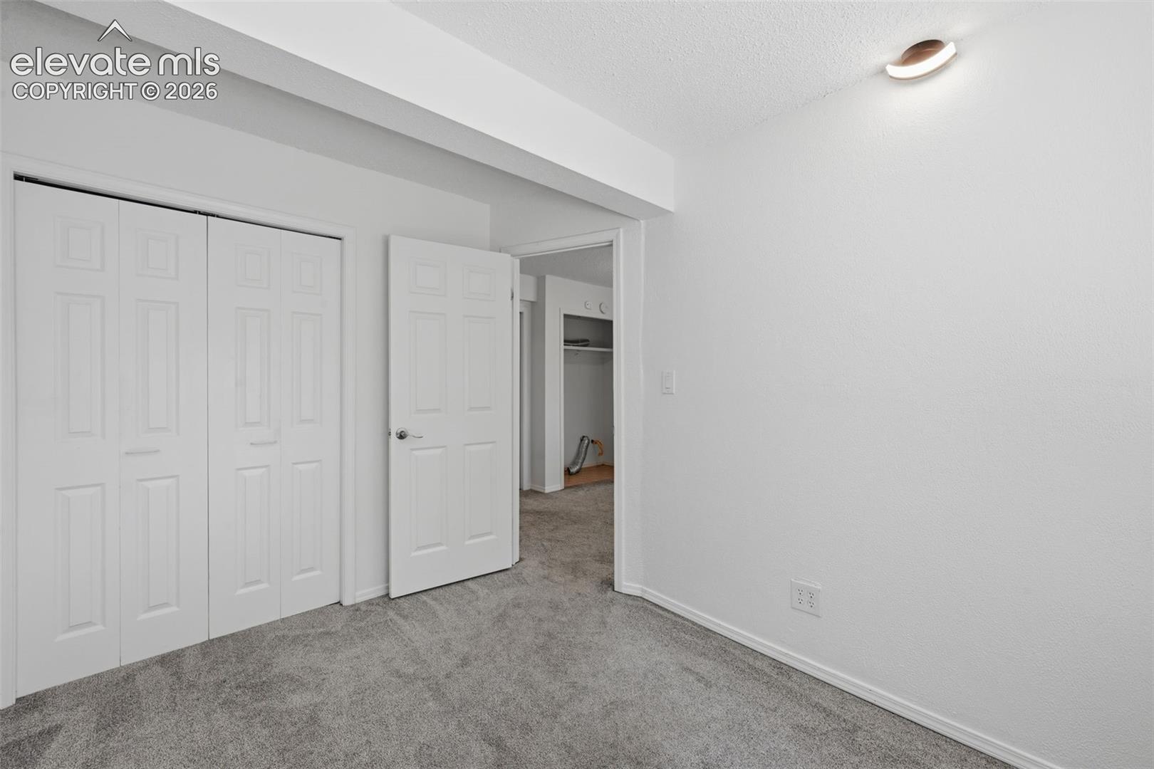 Smaller basement bedroom to the right of the sitting area
