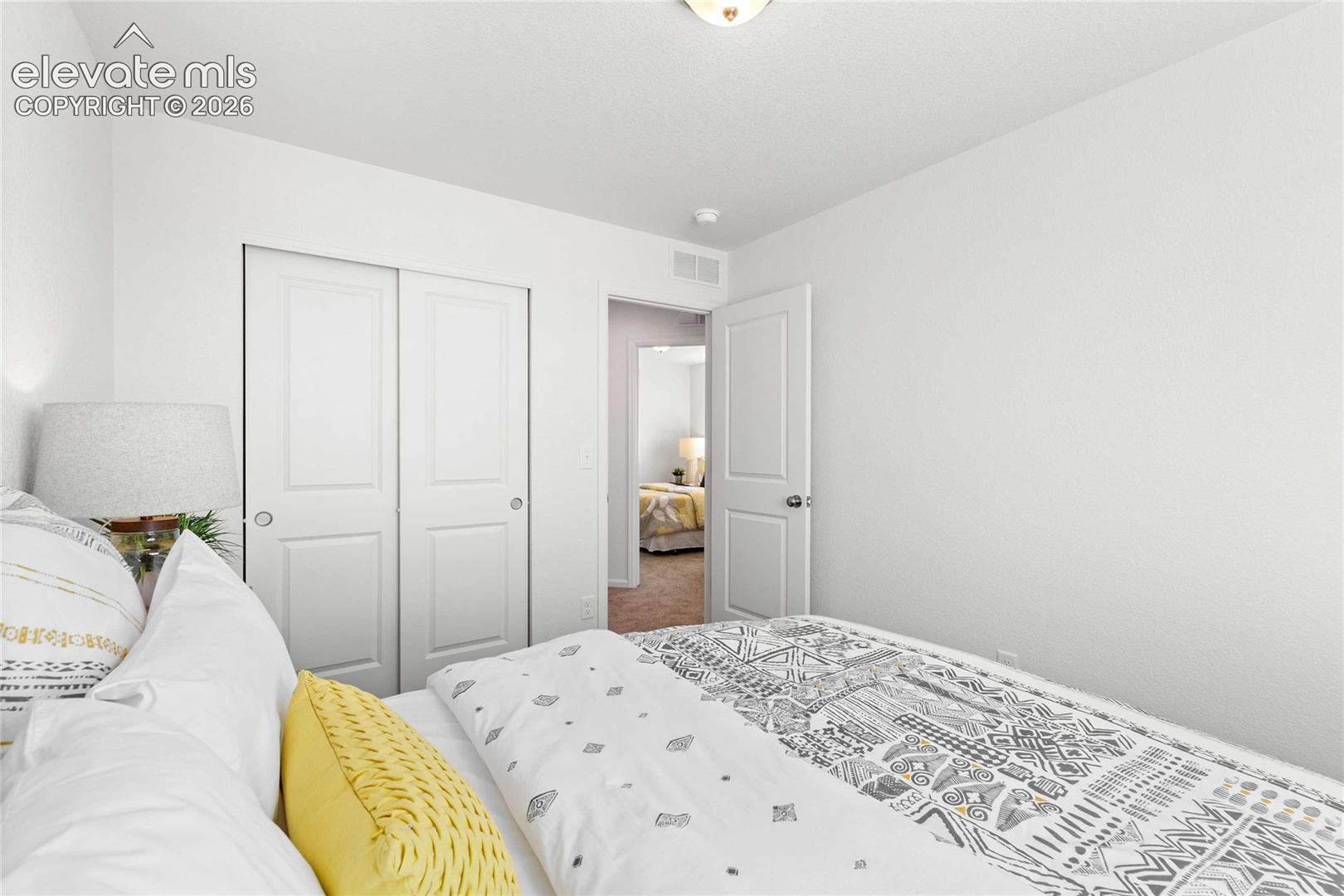 White interior walls, two-panel sliding closet doors, ceiling light fixture, and a single hinged door
*photos  of a model home*