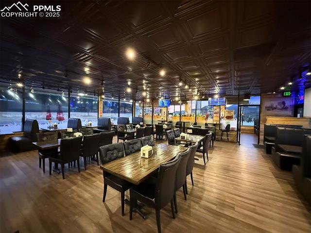 Dining area with wood finished floors and an ornate ceiling