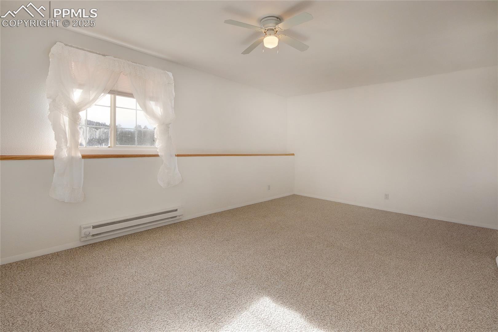 Bedroom 4 in basement with window ledge and ceiling fan