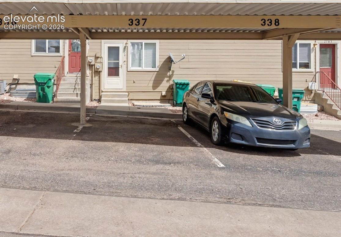The covered parking space is immediately outside the back door
