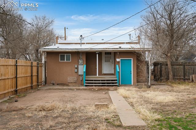 View of front facade with stucco siding, a porch, and entry steps