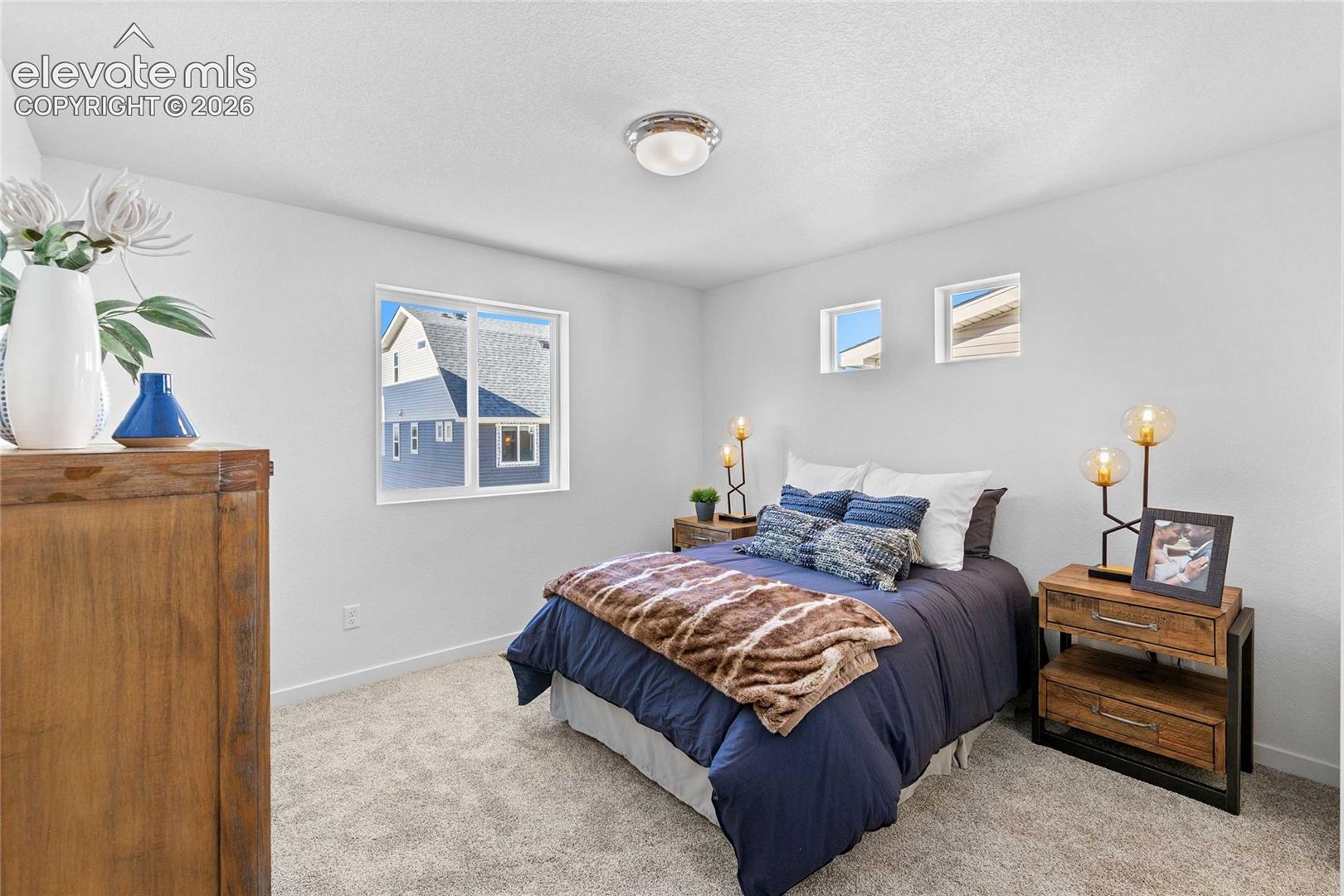 Wall-to-wall carpeting with light-toned walls and multiple windows
*photos of a model home*
