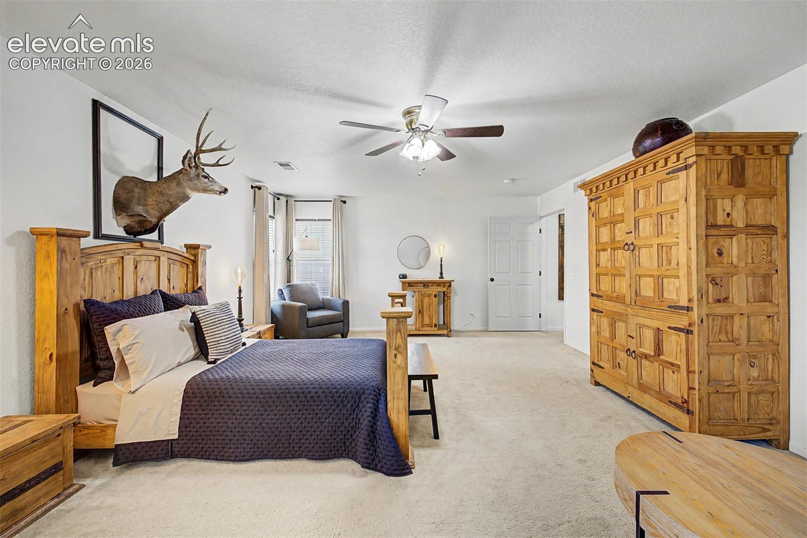 Multiple windows on two walls fill this primary suite with natural light throughout the day, while the room's generous proportions offer flexibility for any layout or lifestyle.