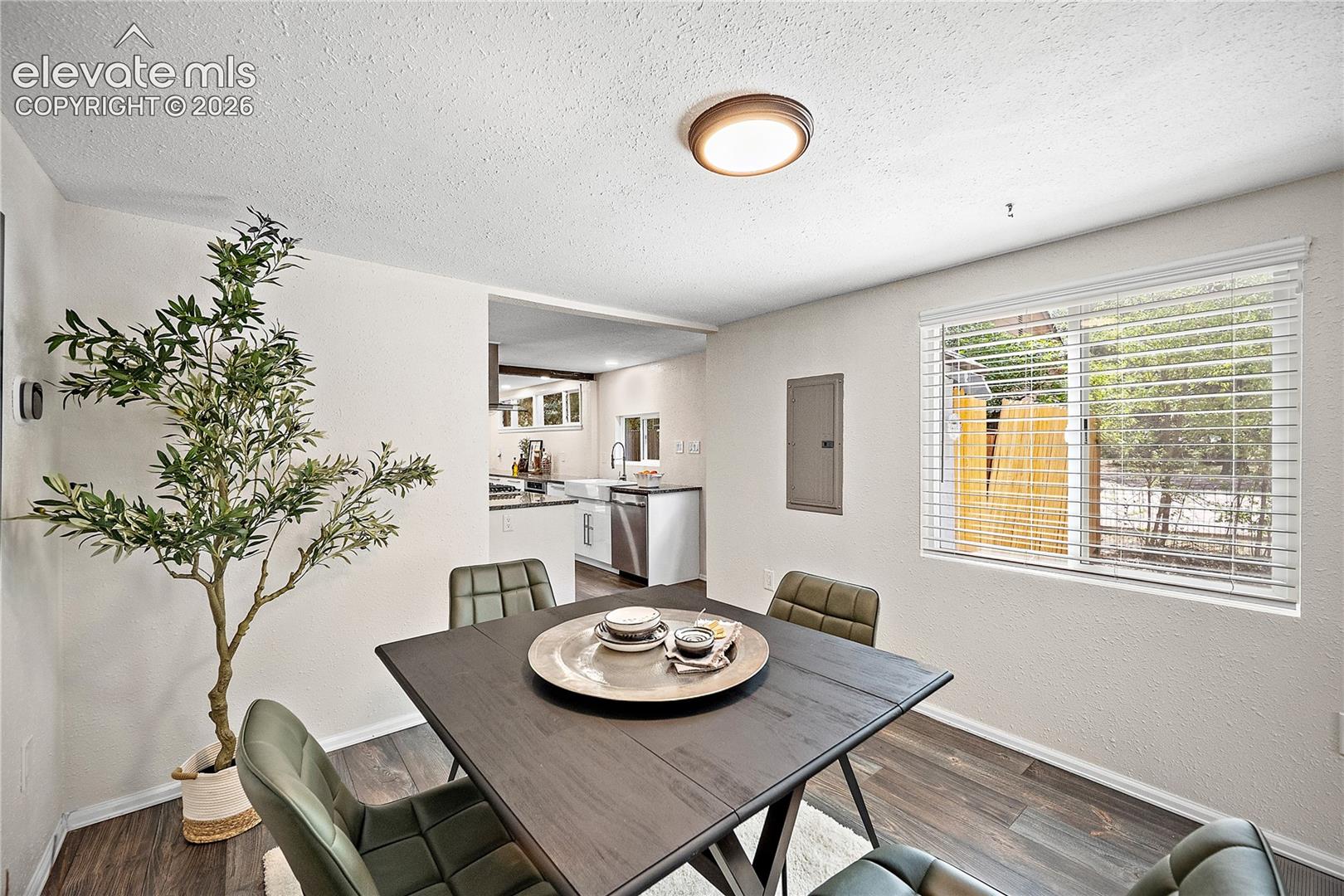 Dining area featuring wood-finish flooring and a window with blinds