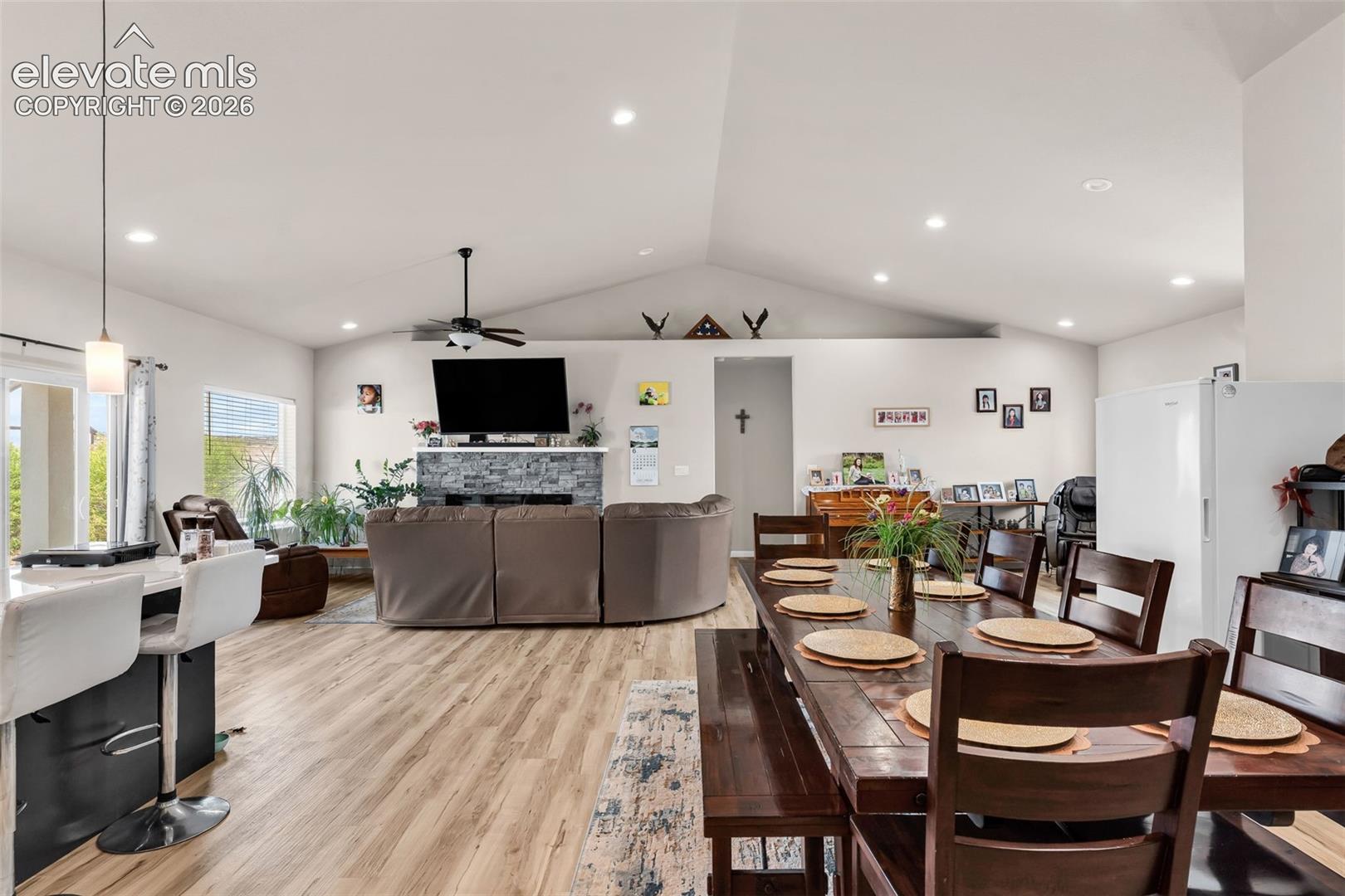 Open-concept living space with vaulted ceilings and wood-finish flooring