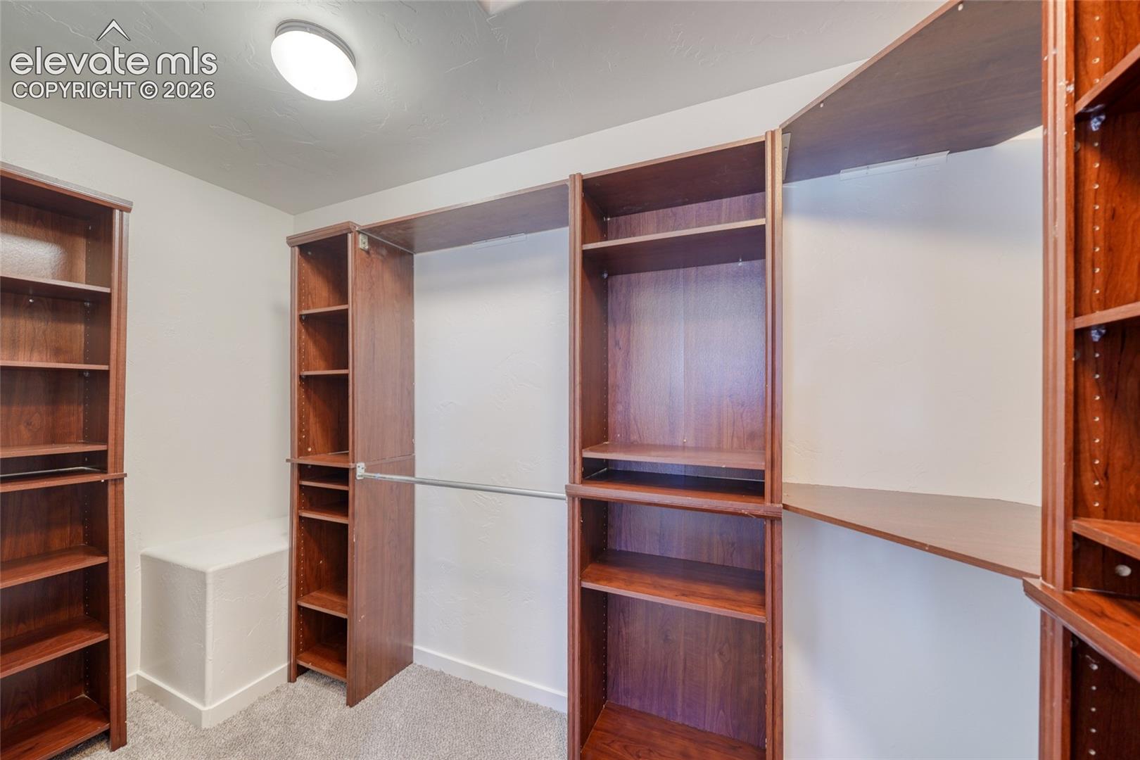 Built-in wood-finish shelving and hanging rods