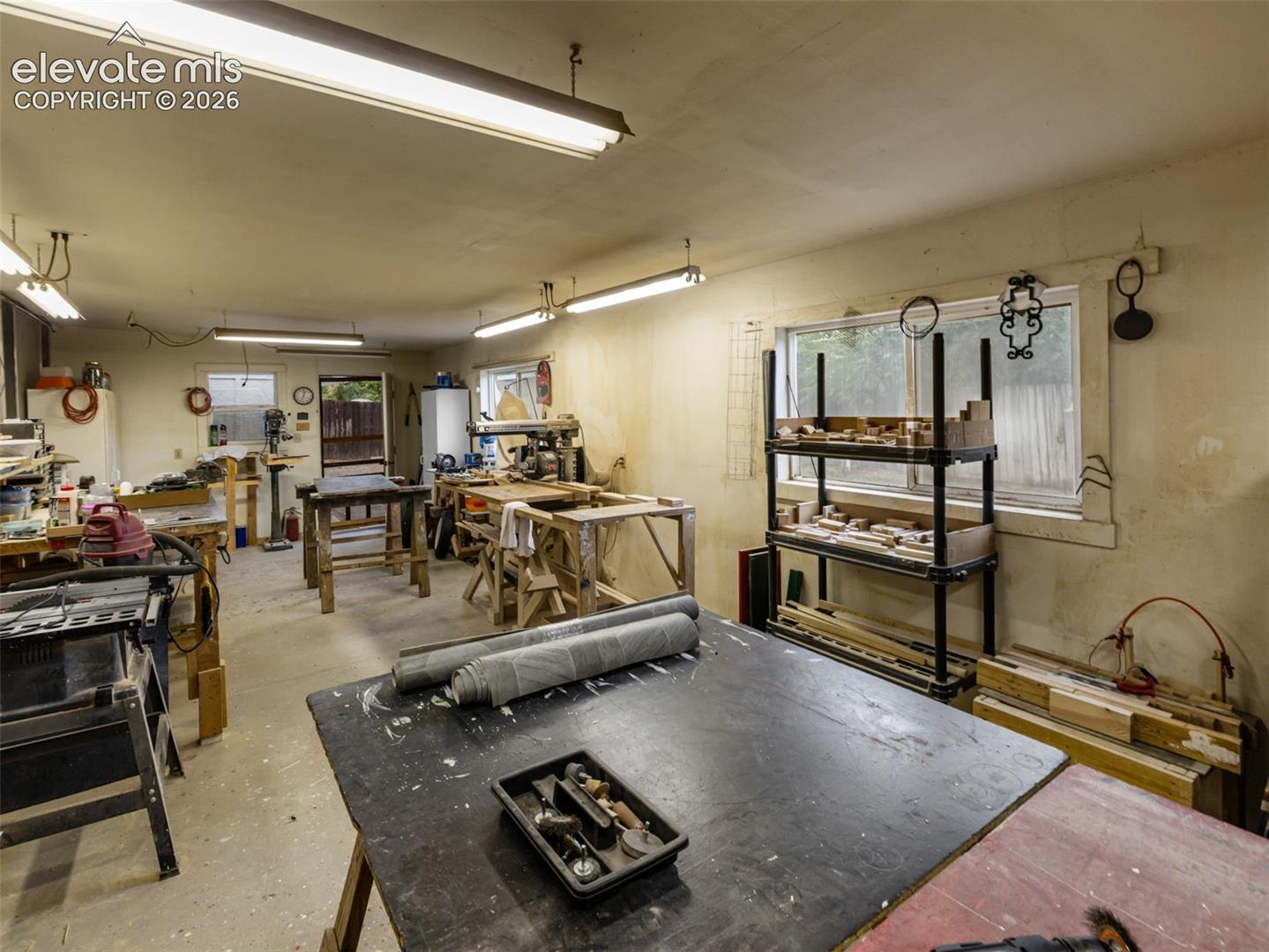 Main Level - attached 12 ft x 24 ft workshop with built ins and heated space, separate entrance off the patio.