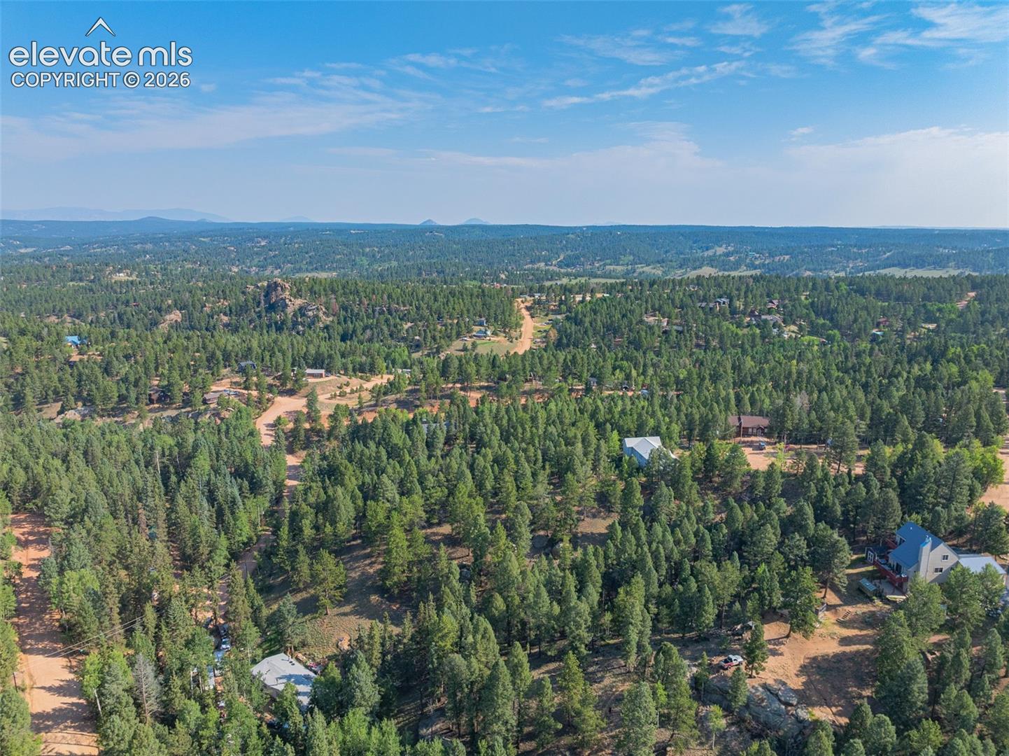 Expansive wooded landscape with scattered residential properties