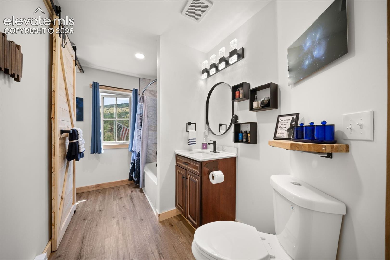 Main leve full bathroom connected to primary and access for guests