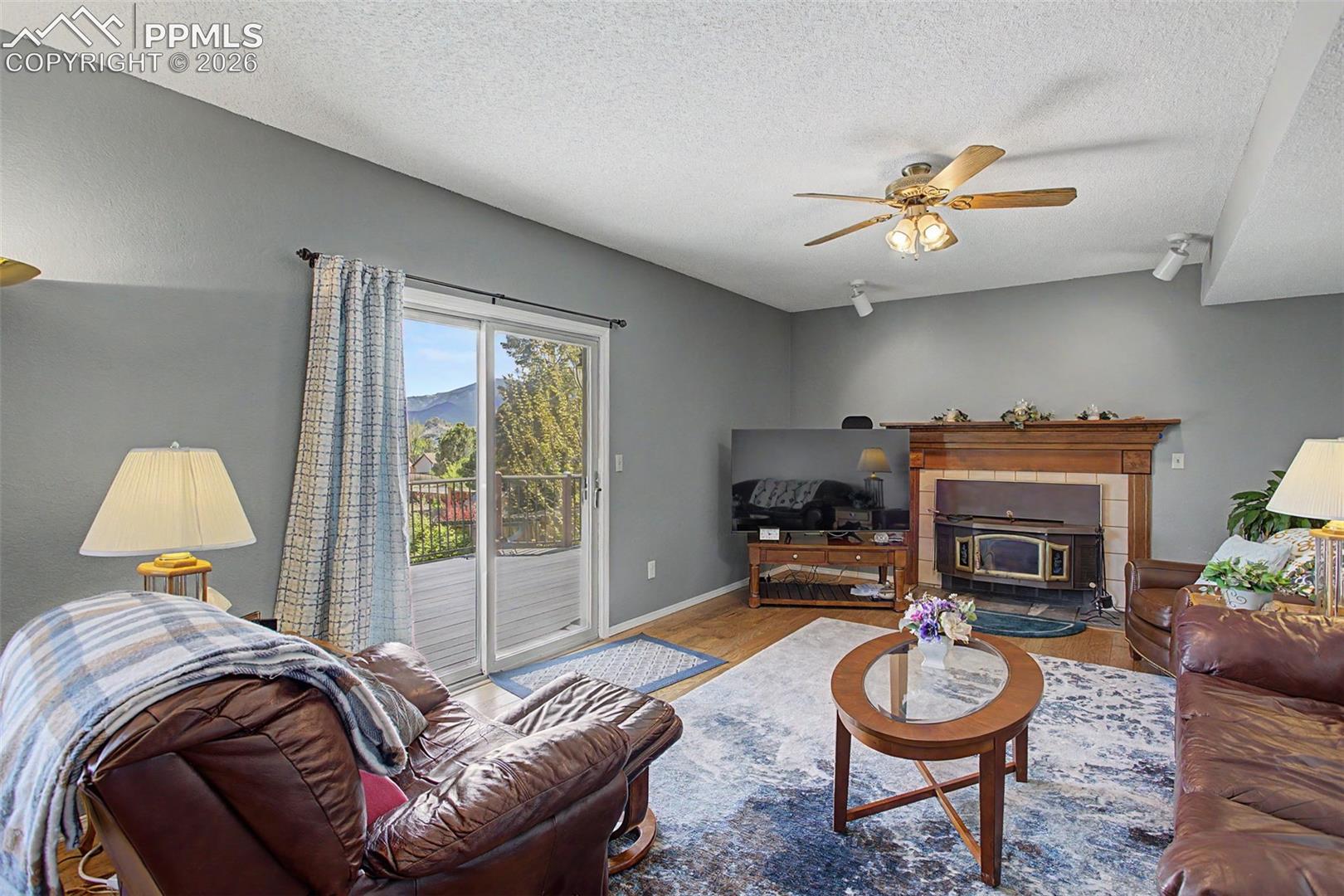 Family room with a wood burning fireplace and walk-out access to the deck.