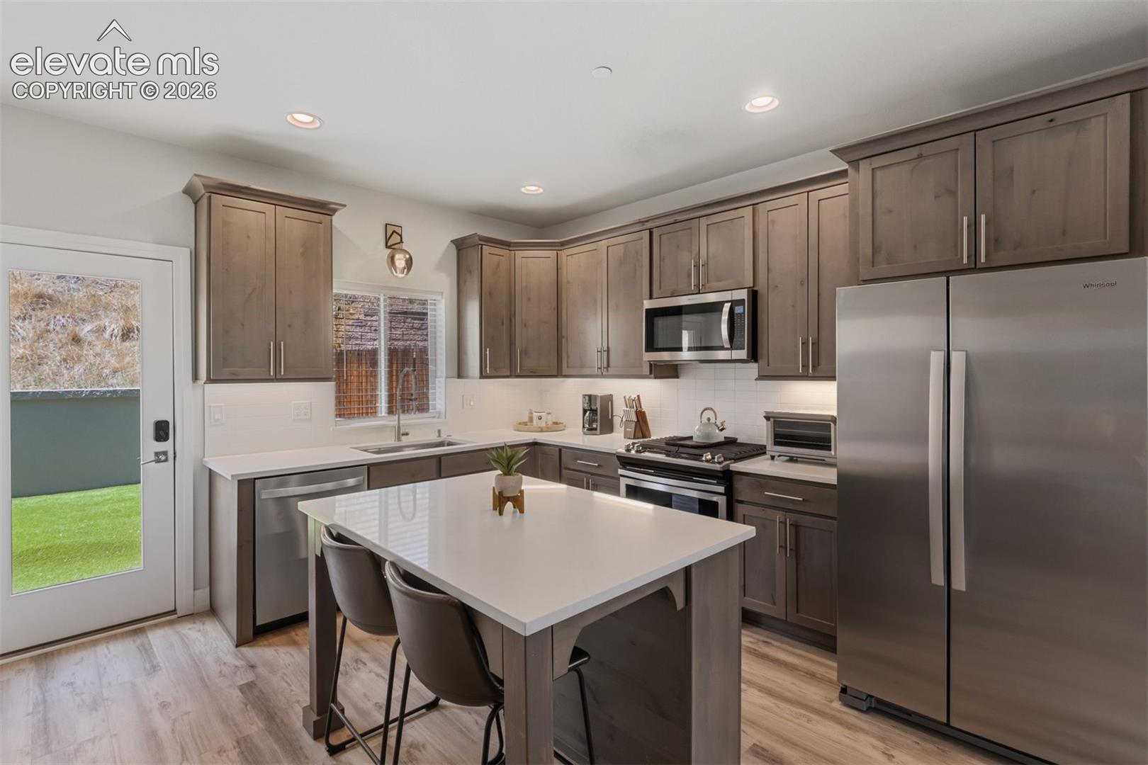 Kitchen with center island and walkout access to back yard