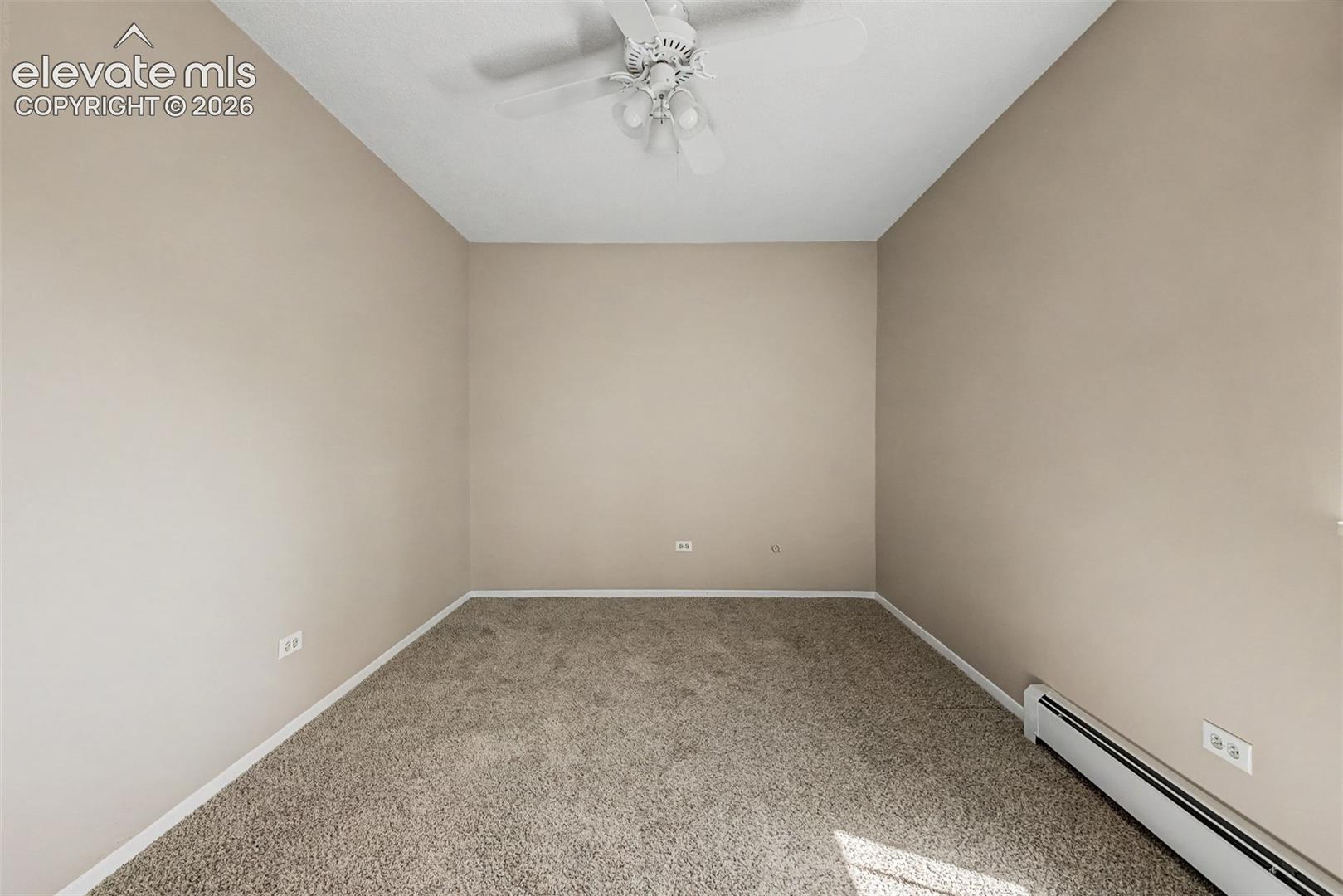 Neutral-toned walls complement the textured carpet flooring