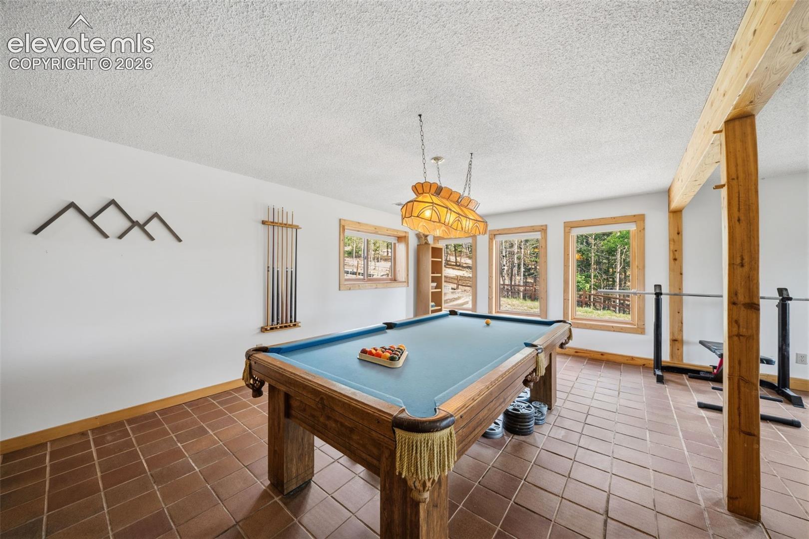 Basement level game room area-pool table stays