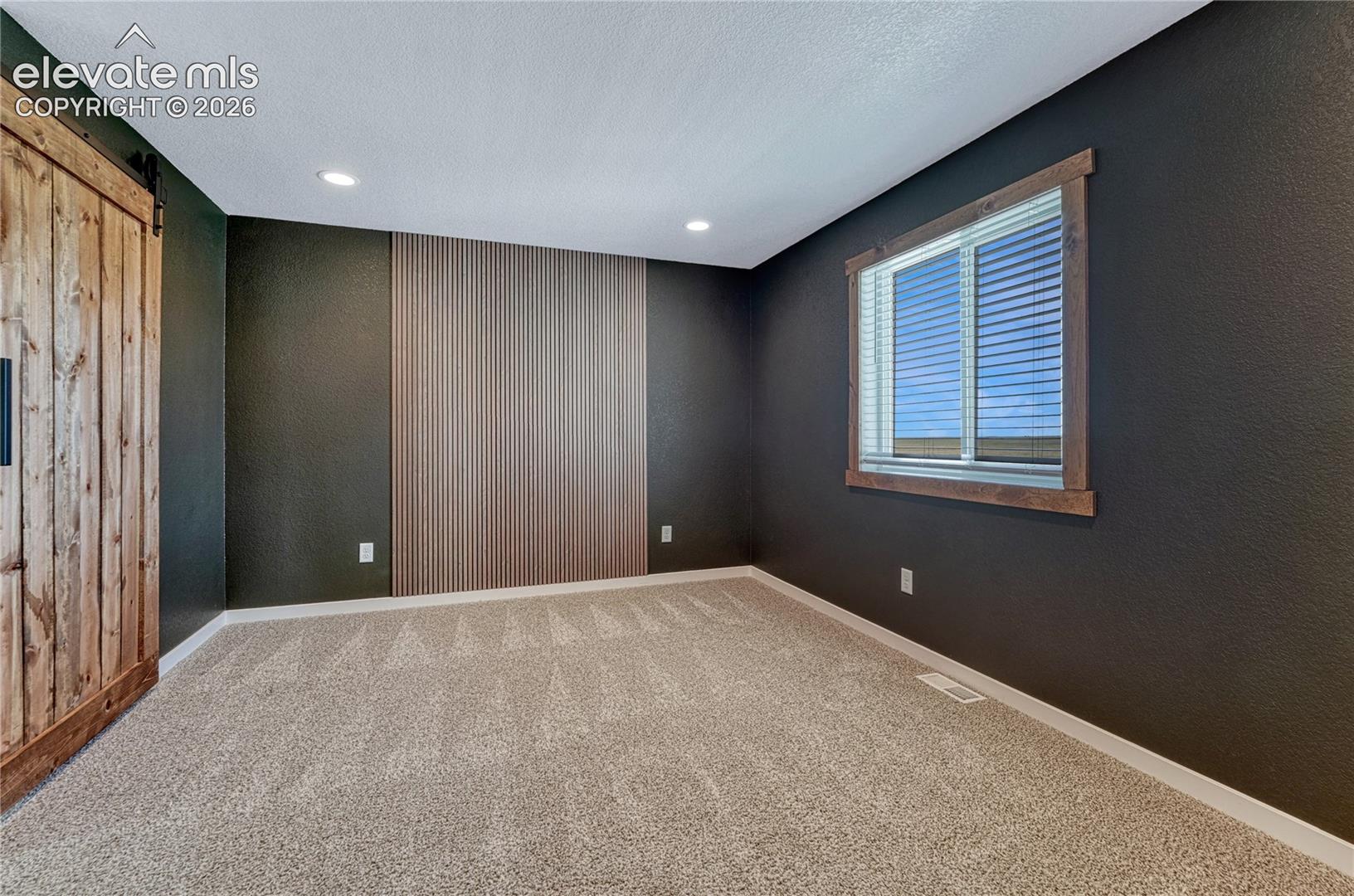 Primary bedroom with feature wall...