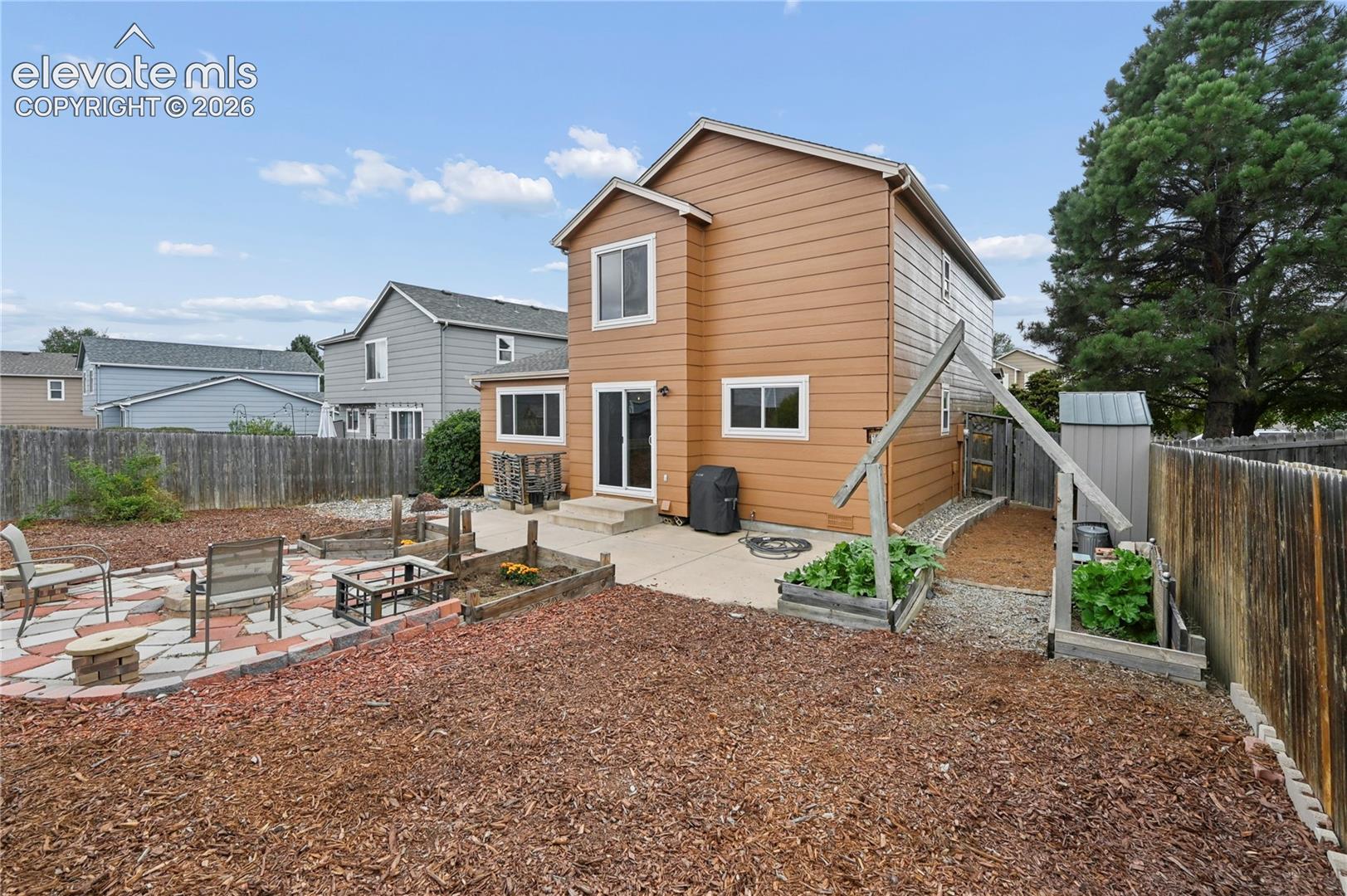 Patios, arbor, garden areas, and nearby storage shed