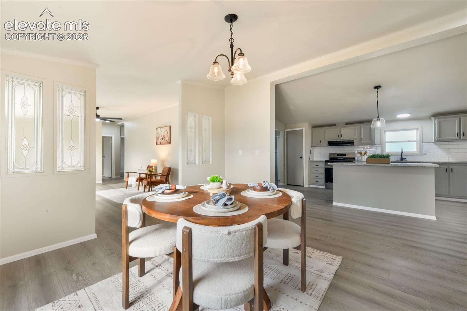 Wood-finish flooring throughout, with a dining area featuring a chandelier