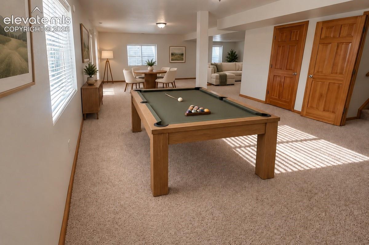 Full expansive walk-out basement. Neutral carpeting, recessed lighting, and natural wood doors.