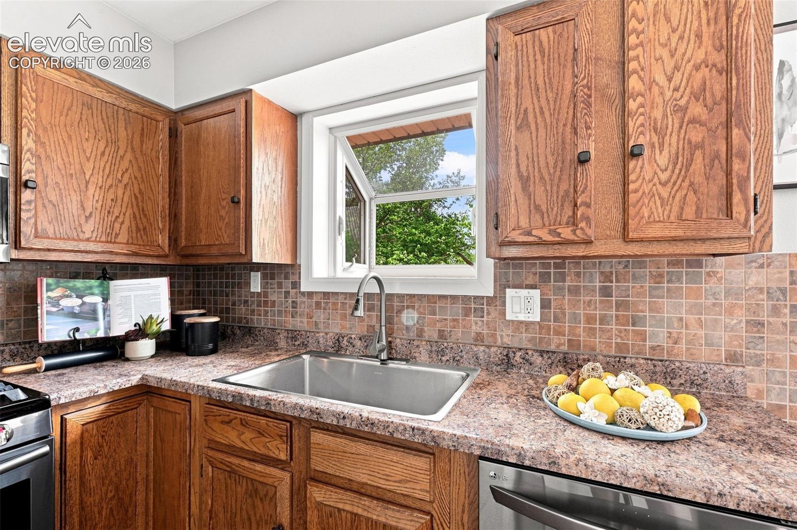 Garden window above sink great for growing herbs or plants, view of large basin sink