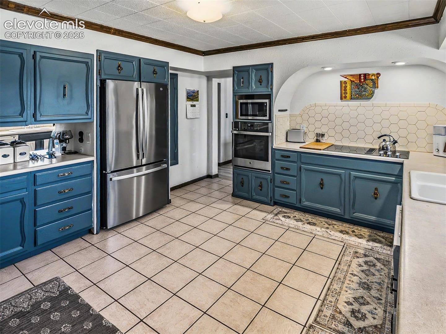 Stainless Steel appliances include a drop in glass cooktop.