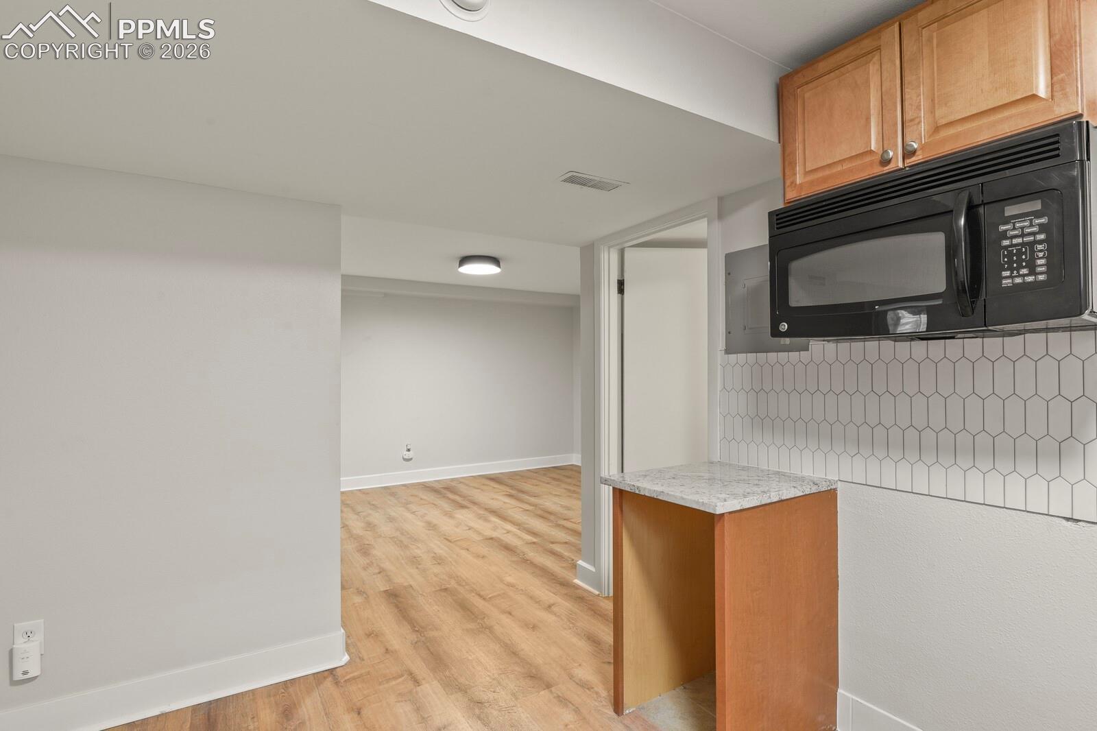 Basement kitchenette semi open to the family room