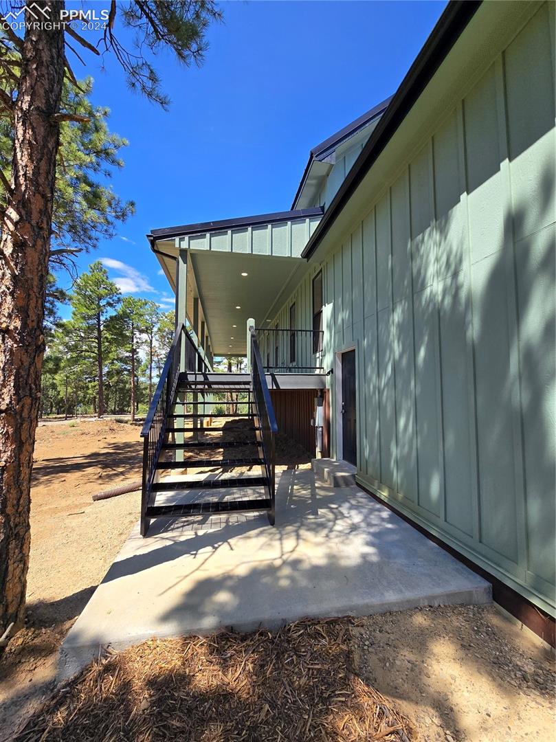 View of garage side entry and stairs to wrap around covered porch