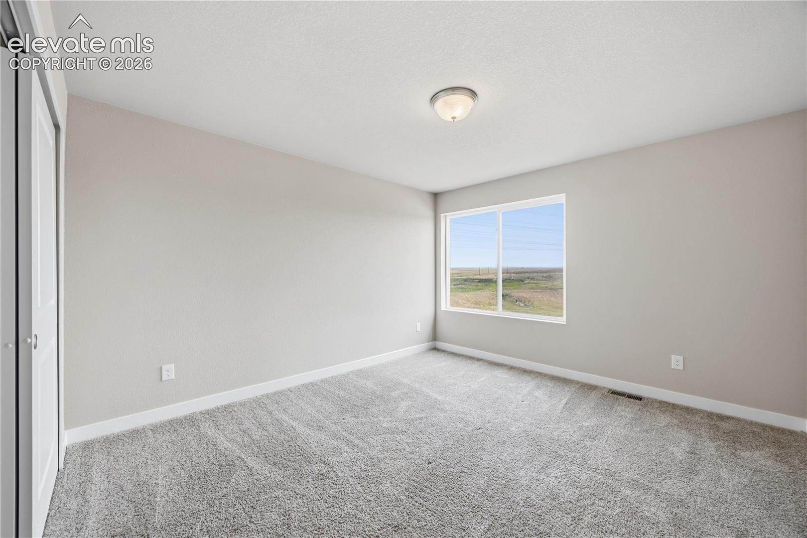 Bedroom #3 has neutral carpet.