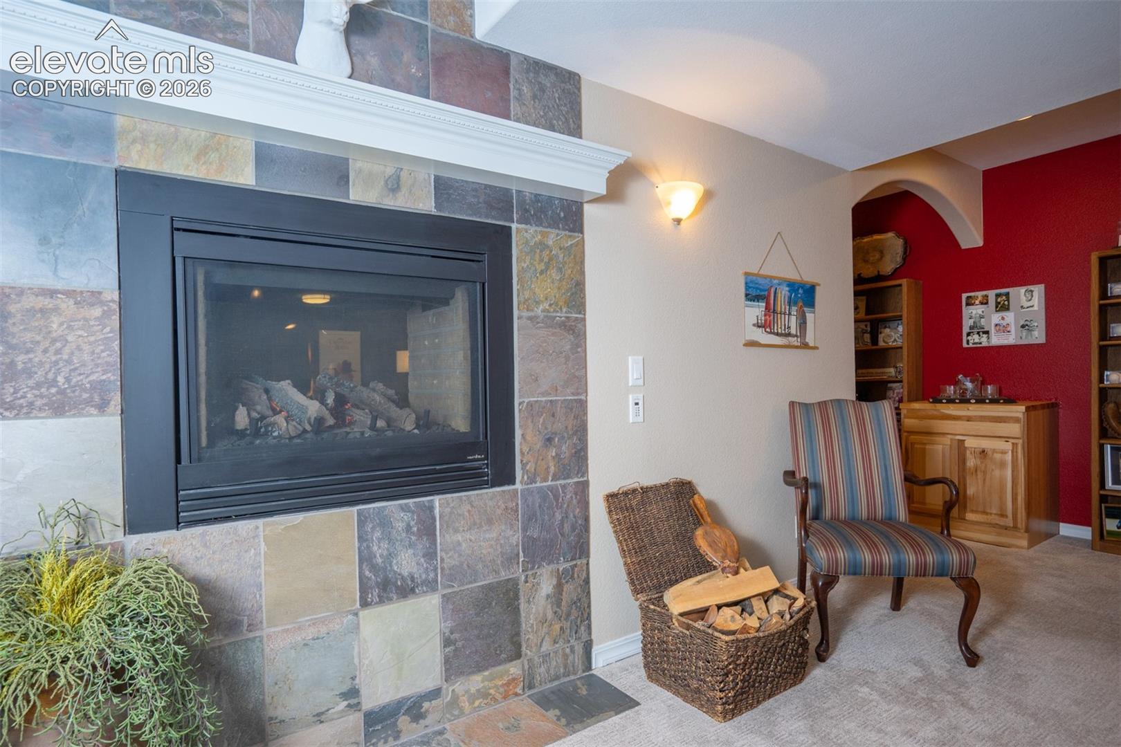 The other side of the two-way fireplace between the dining and living room of the basement apartment