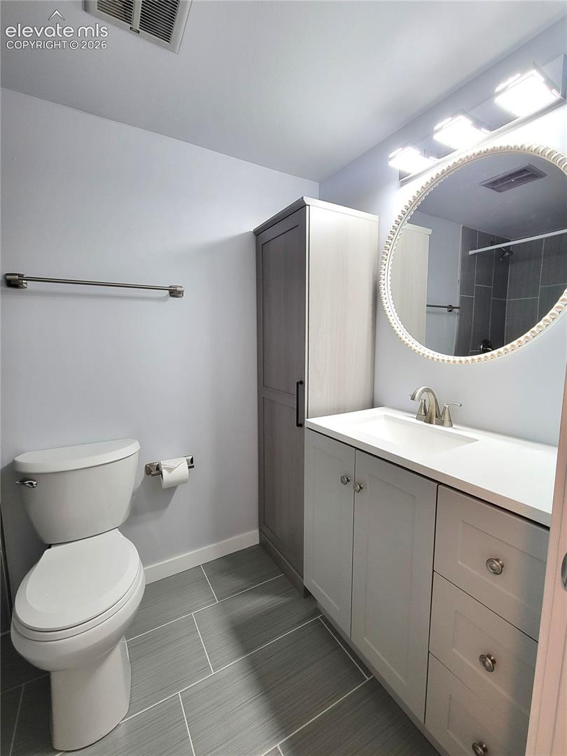 Modern Primary Bathroom featuring a white vanity with integrated sink, brushed nickel faucet, and coordinating hardware
