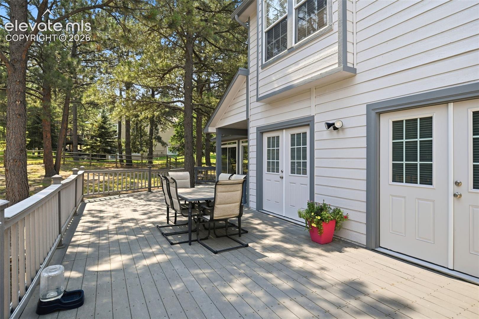 Large outdoor deck with composite decking and white railings