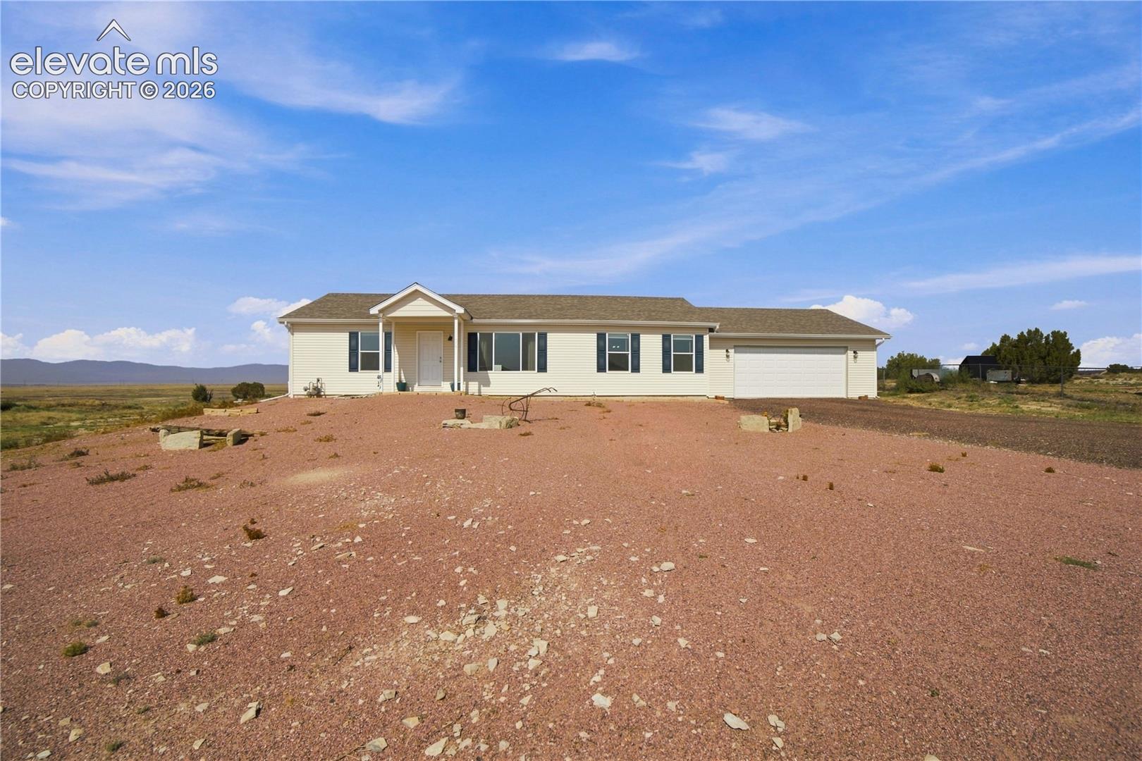 Spacious manufactured home situated on expansive grounds with open vistas across the property