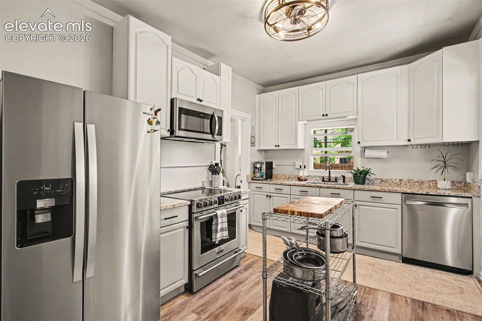 Updated kitchen with stainless steel appliances and granite counters