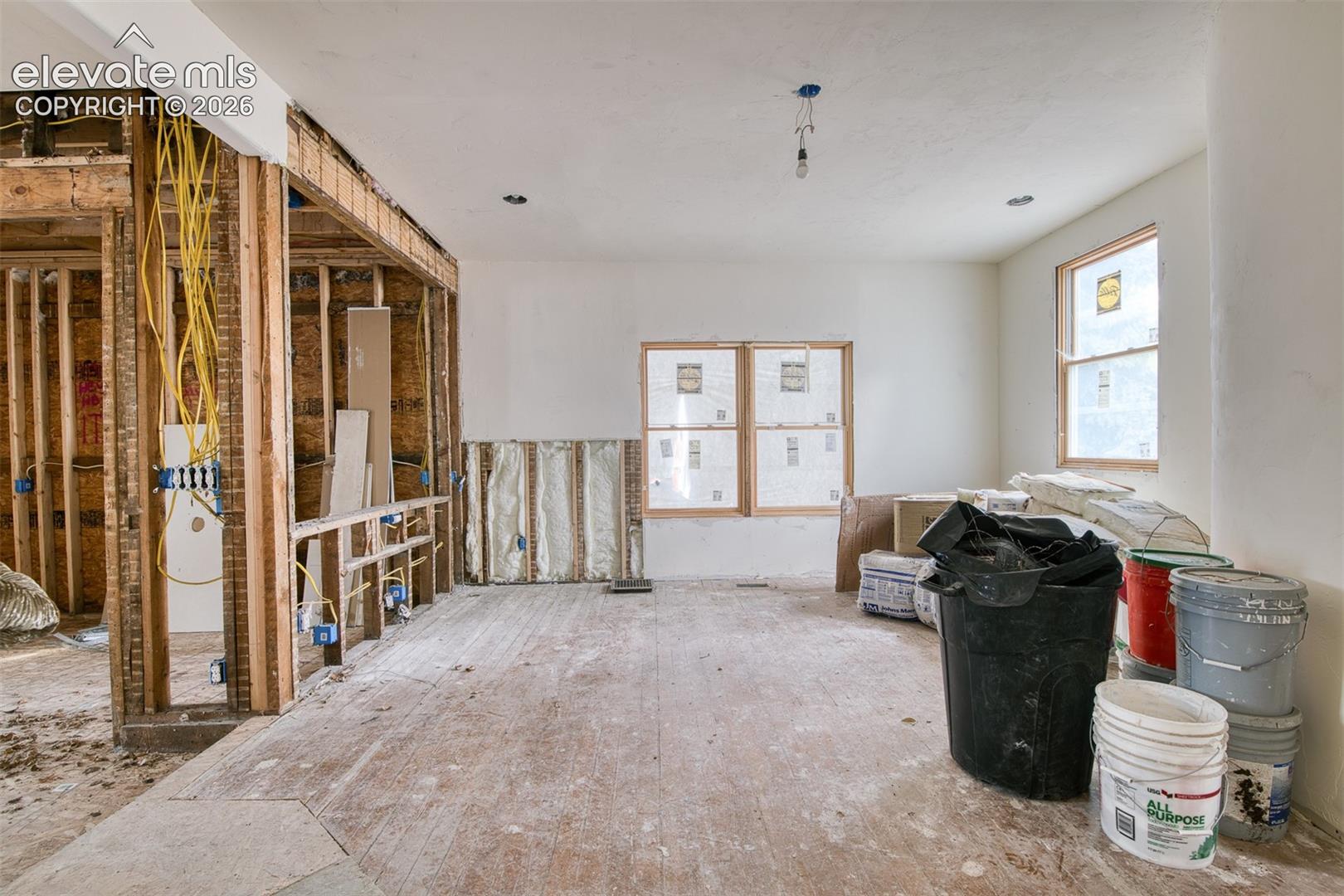 Living room with kitchen and dining areas to the left