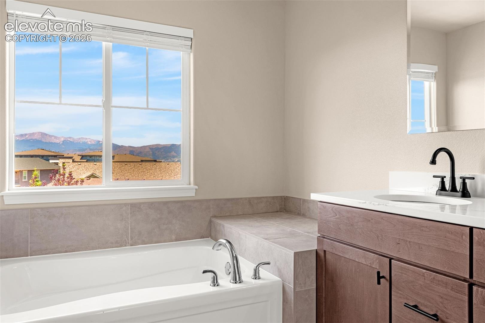 Primary bathroom has large soaking tub with breathtaking views of Pikes Peak and the front range.  