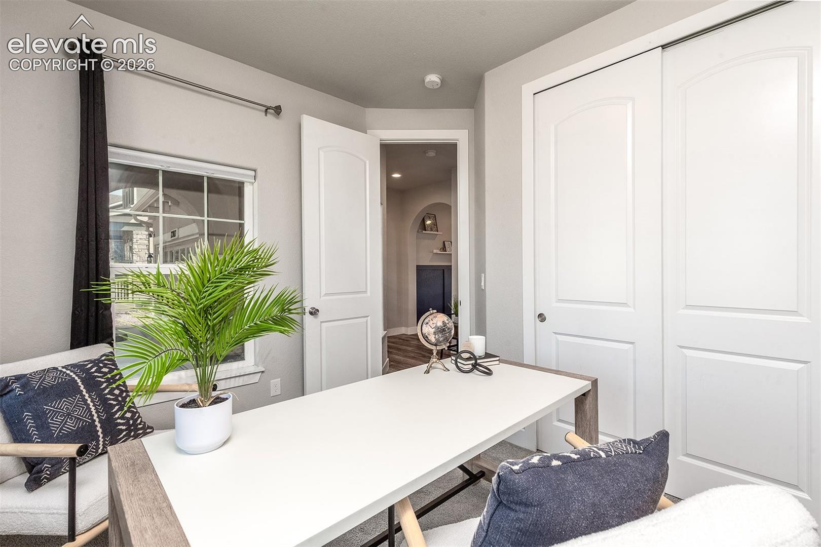Main level bedroom. Currently staged as an office.