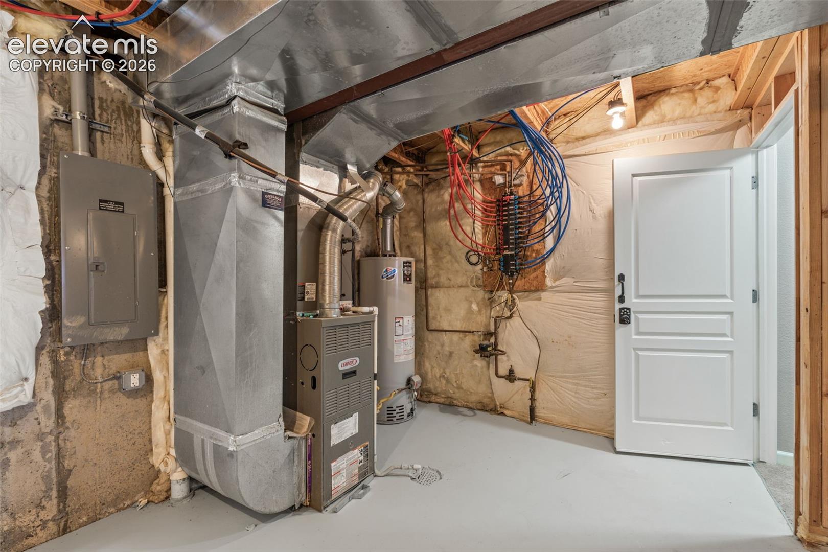 Mechanical utility area featuring a Lennox gas furnace, water heater, electrical panel, PEX manifold plumbing system, and exposed ductwork