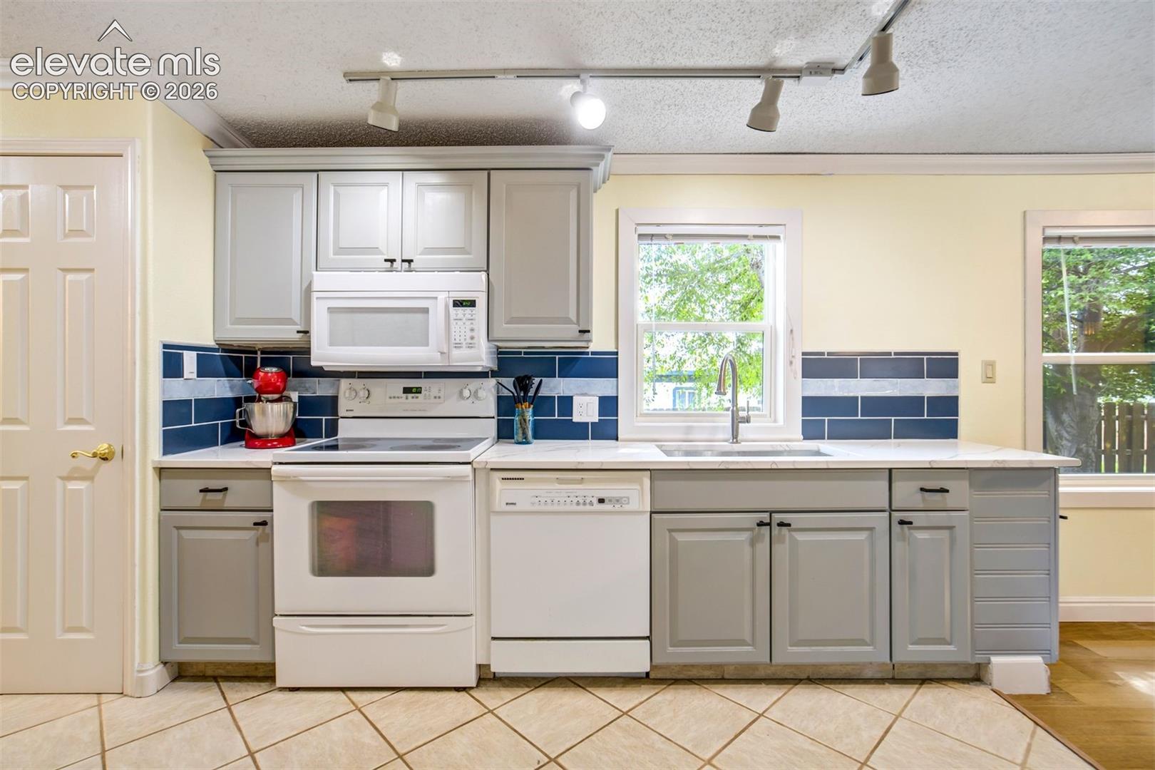 Updated backsplash pairs well with the quartz countertops.
