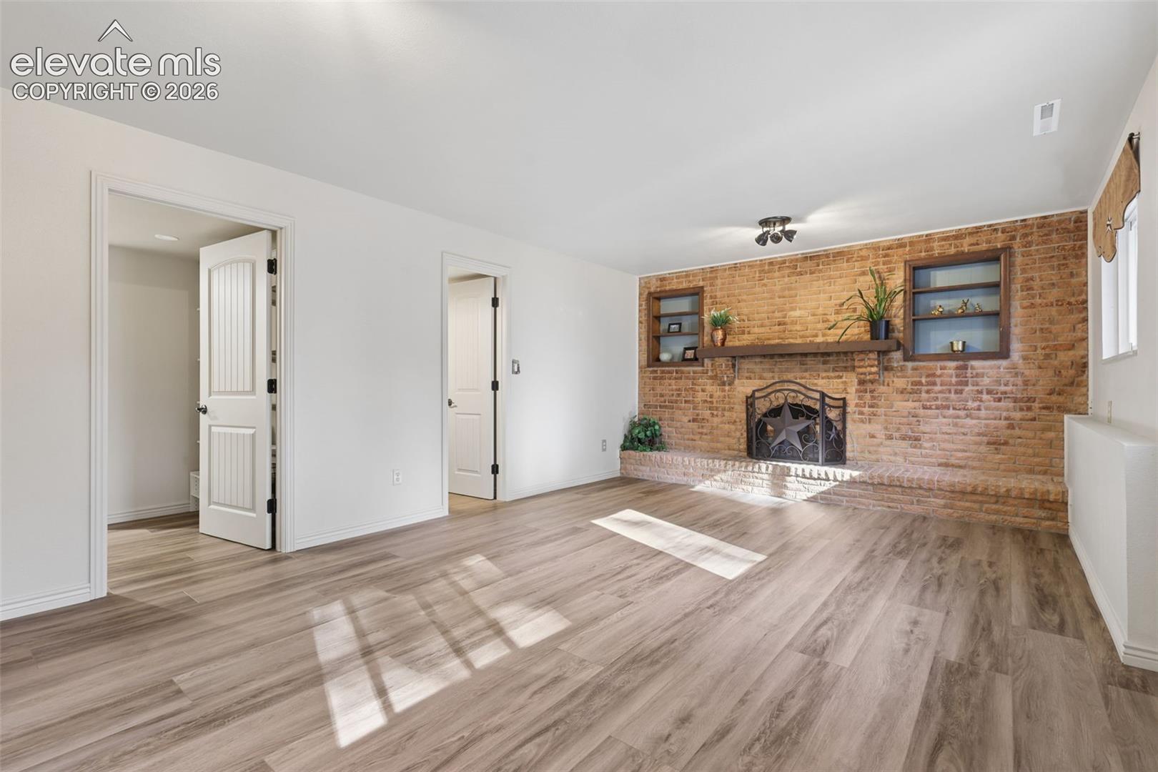 Lower Level Family Room with brick wood burning fireplace
