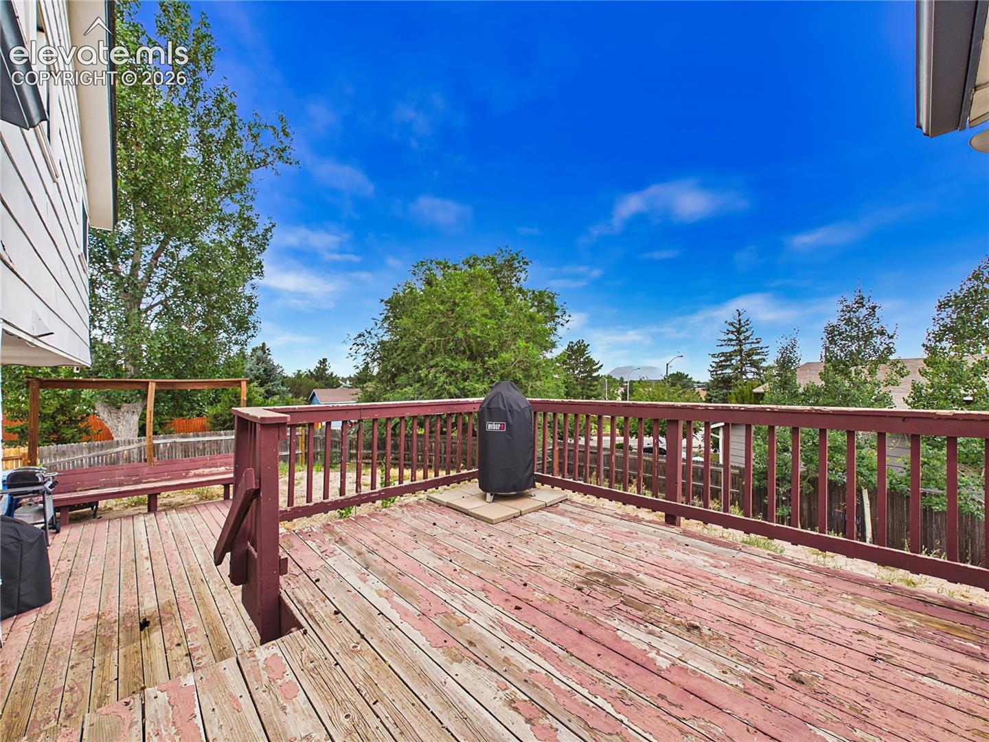 Spacious wood deck with plenty of room for outdoor dining, grilling, and enjoying the private backyard setting.