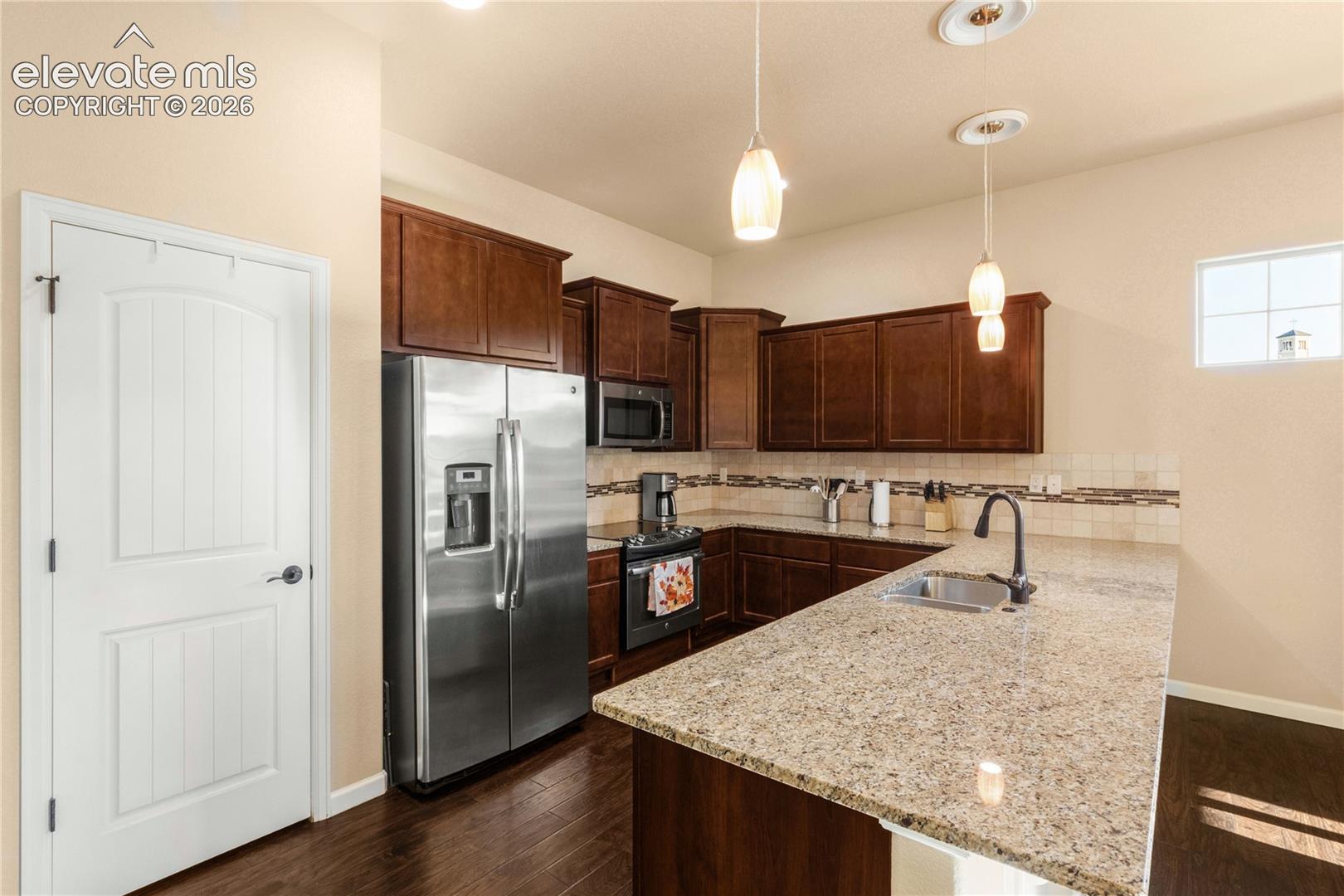 Wood cabinetry and separate pantry closet