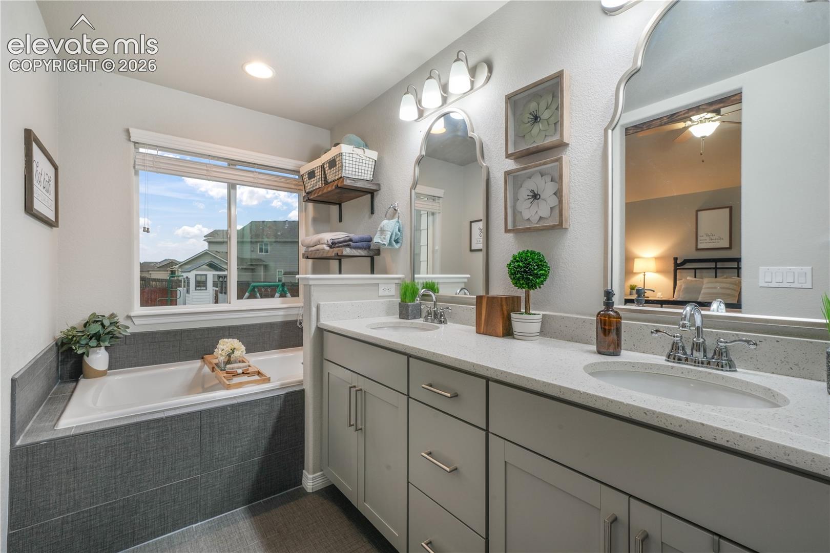 Dual vanity with integrated sinks, light gray cabinetry, and light-toned countertops