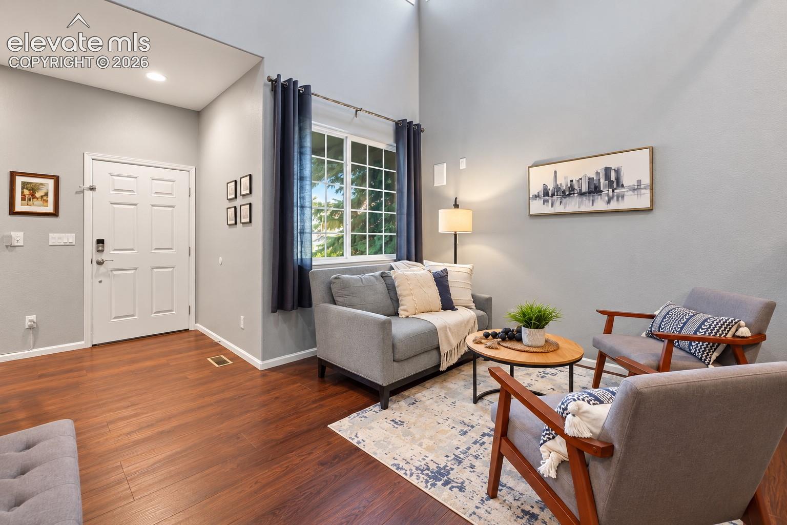 The welcoming front entry flows naturally into a comfortable living room lounge, creating an open, connected space that feels warm and inviting from the moment you arrive.
