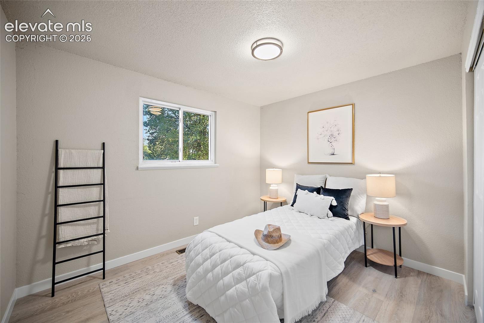 Recessed lighting, wood-finish flooring, and a window with outdoor scenery