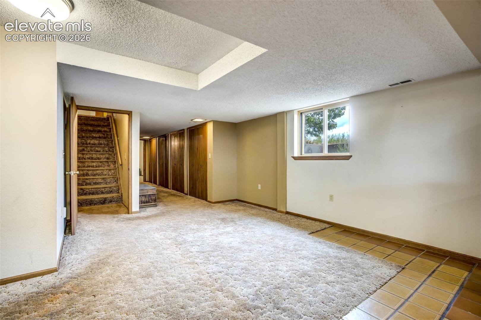 stairway to family room, hall with multiple double closets, leads to 3/4 bath and bedroom4